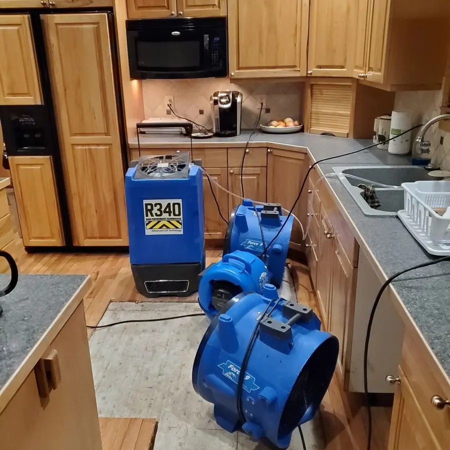 Dehumidifier and air movers drying a Greeley kitchen
