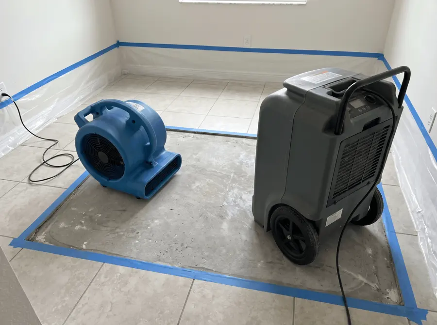 Air mover and dehumidifier running inside plastic containment in a Greeley room