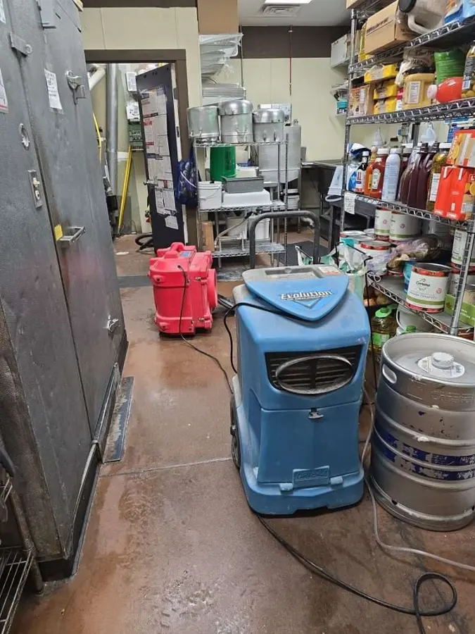 Dehumidifier and air mover drying a Greeley commercial storeroom