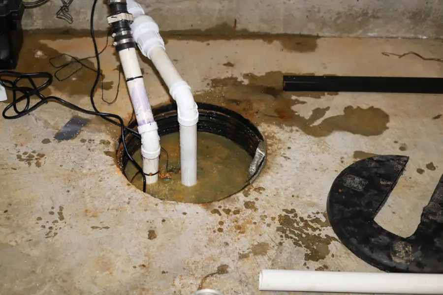 Water standing in a sump pit on a Greeley basement floor